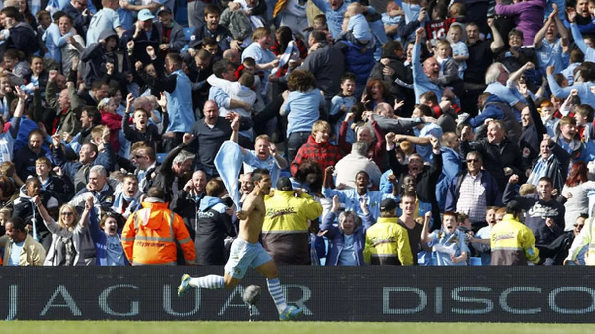 Sergio Aguero wheels away in celebration after scoring a last-minute winner to win Manchester City their first Premier League in 44 years!