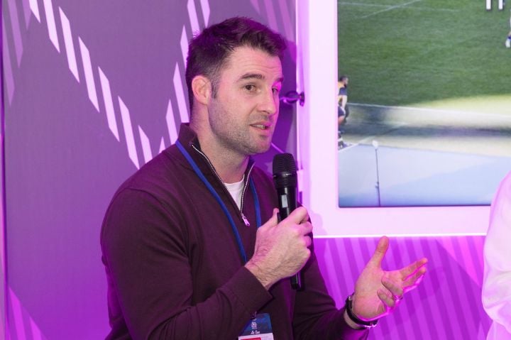 Johnnie Beattie on stage in The Pegasus Lounge at Scottish Gas Murrayfield, speaking to hospitality guests