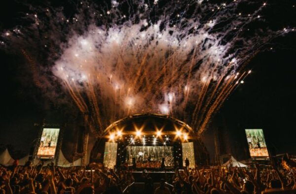 Fireworks going off behind the stage at a concert