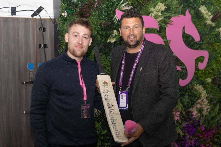 Steve Harmison poses with a guest in The Pegasus Lounge with a signed Lancashire Cricket bat