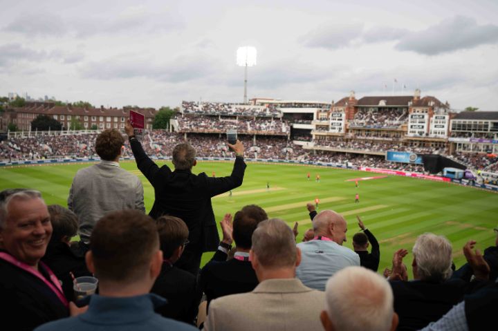 Fans celebrate in The Pegasus Lounge as England hit a six against Pakistan in an IT20 match at KIA Oval Cricket Ground