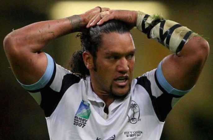 Nicky Little with arms on his head on rugby pitch 