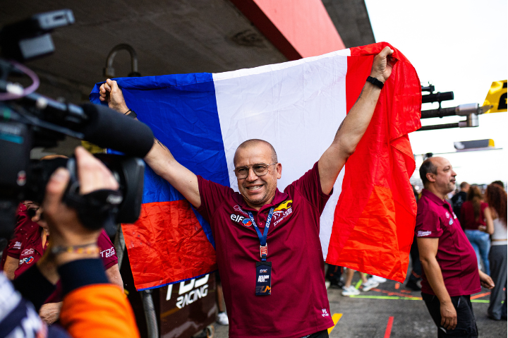 Olivier Panis - celebrating with the French flag. 