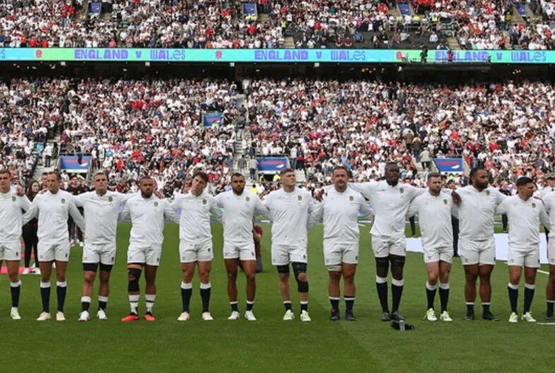 England Rugby Squad lining up in front of a crowd at Allianz Stadium, Twickenham