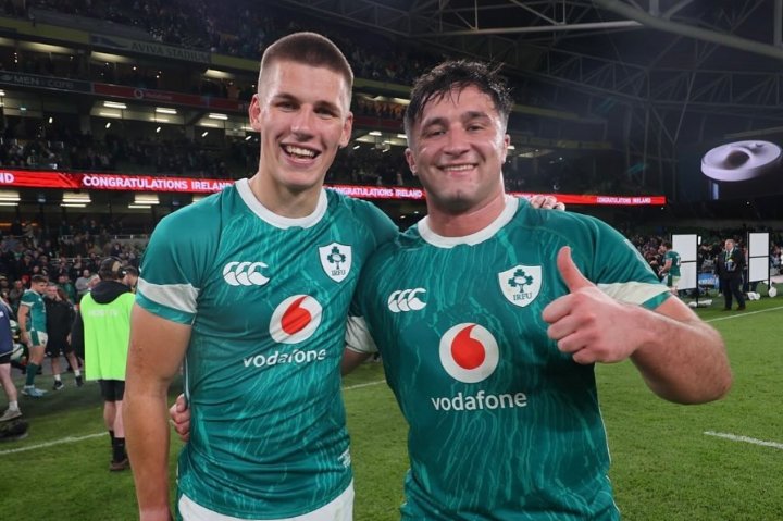 Sam Prendergast celebrating a crucial win for Ireland Rugby with his teammate.